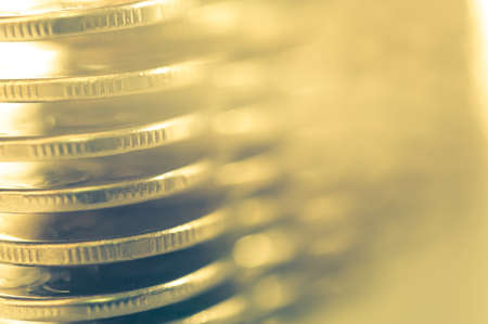 Stack of golden coins macro. Rows of coins for finance and banking concept. Economy trends background for business idea.の写真素材