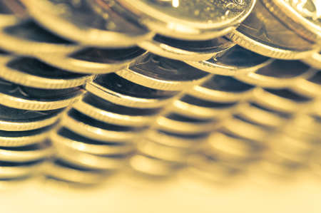 Stack of golden coins macro. Rows of coins for finance and banking concept. Economy trends background for business idea.の写真素材