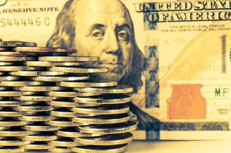 Close-up view of stack coins and cash money american dollars bills. Finance and business concept.の写真素材