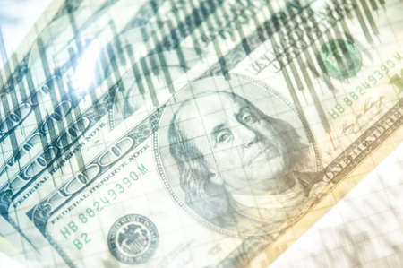 Double exposure Stock market display or forex trading graph and candlestick chart on dollar banknoteの写真素材