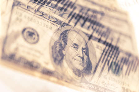 Double exposure Stock market display or forex trading graph and candlestick chart on dollar banknoteの写真素材