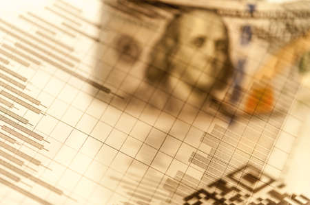 Double exposure Stock market display or forex trading graph and candlestick chart on dollar banknoteの写真素材