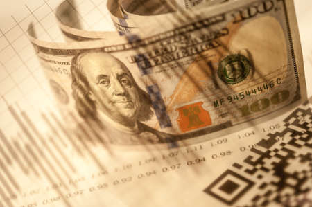 Double exposure Stock market display or forex trading graph and candlestick chart on dollar banknote