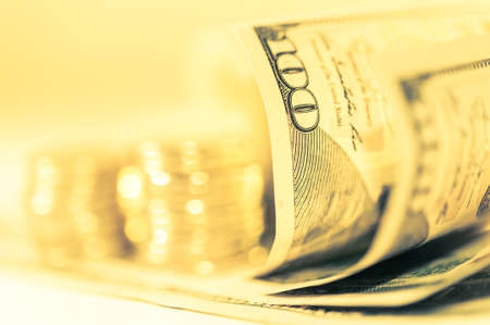 Close-up view of stack coins and cash money american dollars bills. Finance and business concept.の写真素材