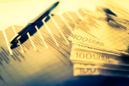 Finance background with money, stock market chart, graph and pen. Economy and business concept.の写真素材