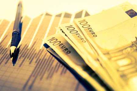 Finance background with money, stock market chart, graph and pen. Economy and business concept.の写真素材