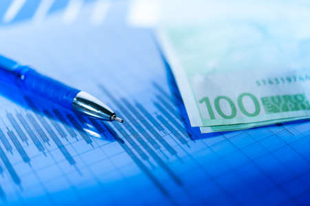 Finance background with money, stock market chart, graph and pen. Economy and business concept.の写真素材
