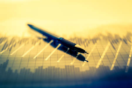 Finance background with money, stock market chart, graph and pen. Economy and business concept.の写真素材
