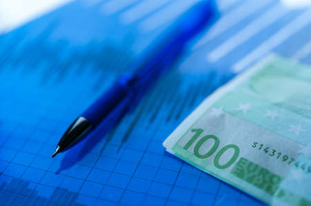 Finance background with money, stock market chart, graph and pen. Economy and business concept.の写真素材
