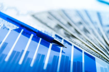 Finance background with money, stock market chart, graph and pen. Economy and business concept.の写真素材