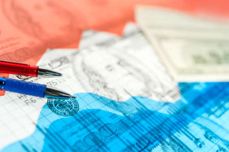 Finance background with money, stock market chart, graph and pen. Economy and business concept.の写真素材