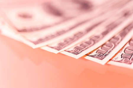 Finance background with money, stock market chart, graph and pen.の写真素材