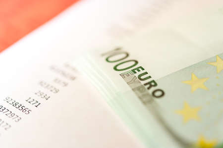 Close up view of cash money euro bills on a pink background. Finance and business theme.