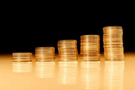 Stack of gold coins macro. Rows of coins for finance and banking concept. Economy trends background.の写真素材
