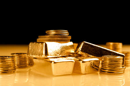 Gold bars and stack of gold coins. Background for finance banking concept. Trade in precious metals.