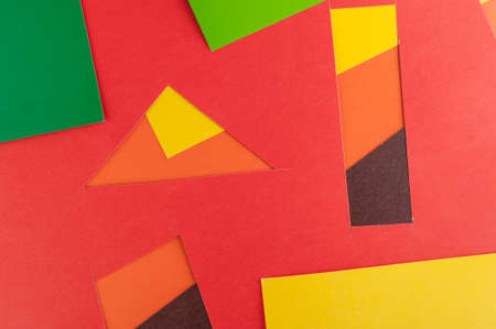 Multi-colored real vivid paper sheets texture background. Red, brown, yellow, orange, green.