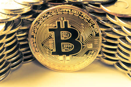Bitcoin on the background of the wall of coins. Economy trends virtual digital currency concept.