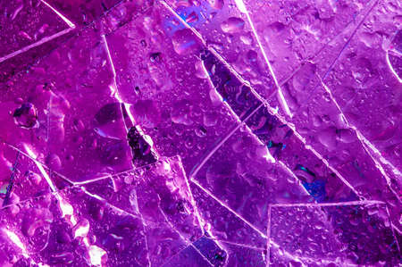 Background in the style of the 80-90s. Real texture of broken glass and drops in bright acid colors.の写真素材