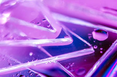 Background in the style of the 80-90s. Real texture of broken glass and drops in bright acid colors.の写真素材