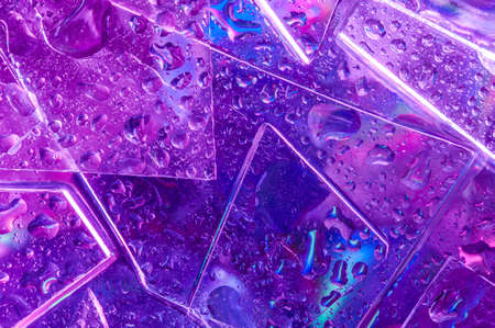 Background in the style of the 80-90s. Real texture of broken glass and drops in bright acid colors.の写真素材