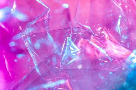 Holographic background in the style of the 80-90s. Real texture of cellophane film in bright acid colors.の写真素材