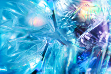 Holographic background in the style of the 80-90s. Real texture of cellophane film in bright acid...