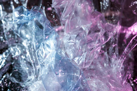 Holographic background in the style of the 80-90s. Real texture of cellophane film in bright acid colors.の写真素材