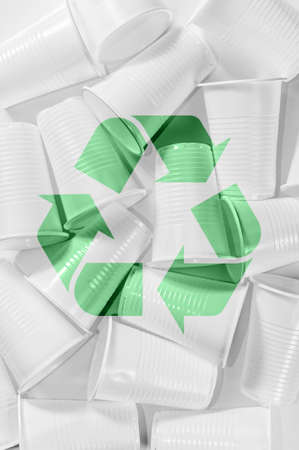 Disposable plastic cups and recycling sing on a white background. Minimalistic ecologically clean...
