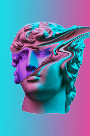 Plaster sculpture of young man face in a pop art style. Statue of Antinous head. Creative concept colorful neon image with ancient roman sculpture Antinous head. Cyberpunk, webpunk and surreal style.の写真素材