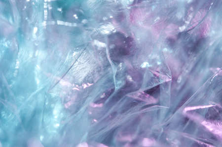 Holographic background in the style of the 80-90s. Real texture of cellophane film in bright acid...