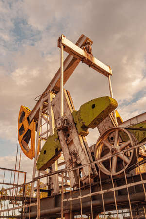 Oil pump rig. Oil and gas production. Oilfield site. Pump Jack are running. Drilling derricks for fossil fuels output and crude oil production. War on oil prices. Global coronavirus COVID 19 crisis.の写真素材