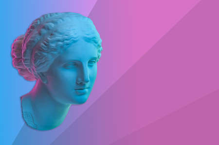 Statue of Venus de Milo. Creative concept colorful neon image with ancient greek sculpture Venus or Aphrodite head. Webpunk, vaporwave and surreal art style. Pink and blue duotone effects.の写真素材