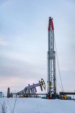 Oil and Gas Drilling Rig. Oil drilling rig operation on the platform in oil and gas industry. Global coronavirus COVID 19 crisis. Petroleum concept. War on oil prices. Environmental pollution.の写真素材