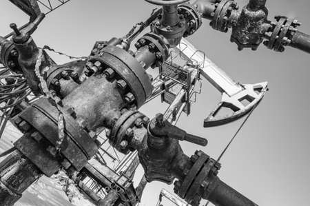 Oil pump rig. Oil and gas production. Oilfield site. Pump Jack are running. Drilling derricks for fossil fuels output and crude oil production. War on oil prices. Global coronavirus COVID 19 crisis.の写真素材