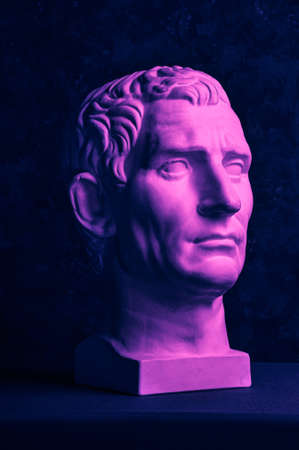 Statue of Guy Julius Caesar Octavian Augustus. Creative concept colorful neon image with ancient roman sculpture Guy Julius Caesar Octavian Augustus head. Cyberpunk, vaporwave and surreal art style.の写真素材