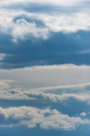 Natural sky composition. Sunny vast blue sky abstract background. Beautiful cloudscape, view over white fluffy clouds. Freedom concept, on the heaven. Element of design.の写真素材