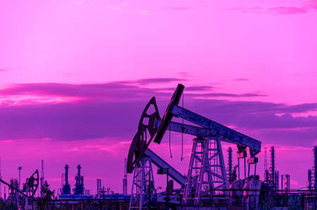 Petroleum concept. Oil pump rig. Oil and gas production. Oilfield site. Pump Jack are running....