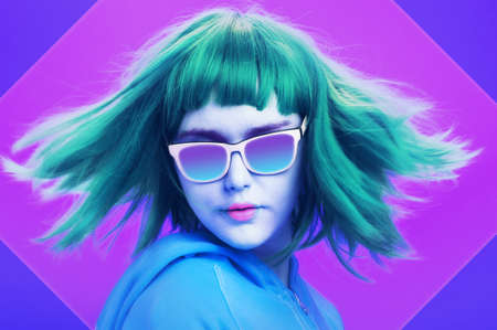 Art collage with alternative funky girl with blue hair on a bright blue purple background. Close up...