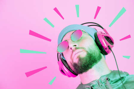 Pop art style collage. Funky bearded hipster DJ in headphone and sunglasses. Listening streaming music in smartphone player app. Contemporary art poster. Rave music nightclub party. Minimal concept.の写真素材