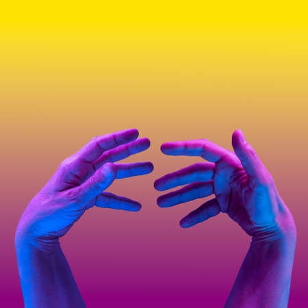 Hands in a surreal style in violet blue neon colors. Modern psychedelic creative element with human palm for posters, banners, wallpaper. Copy space for text. Magazine style template. Pop art culture.の写真素材