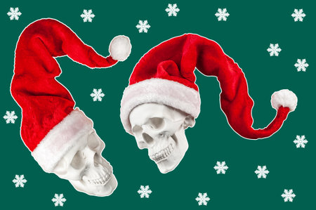 Two white spooky skull in bright red Santa Claus hat on green backdrop with snowflakes. Funky xmas decor. Crazy concept of holidays, cool party, 2023 New Year and Merry Christmas. Winter holiday mood.の写真素材