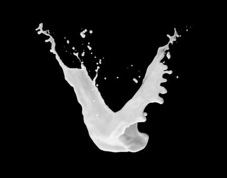 Milk splash in air isolated on blackの写真素材
