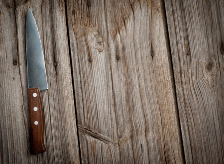 Knife on wooden kitchen table with copy spaceの写真素材