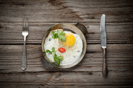 Fried egg on wooden background  close upの写真素材