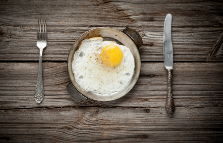 Fried egg on wooden background close upの写真素材