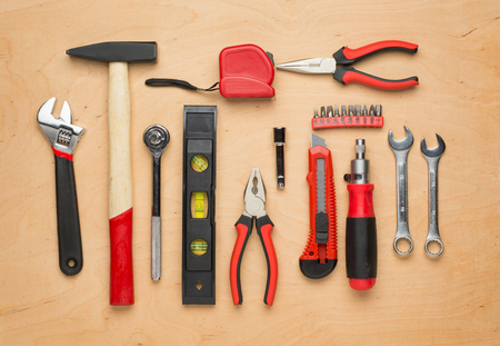 Set of tools on a wood panel with space for text
