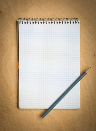 notebook with pencile on a wooden backgroundの写真素材