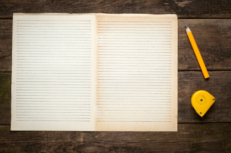 Blank Note Book With Wood Pencil on Wooden Table Desk Background, Rustic Style, Concept and Idea for Write Your Text Here.の写真素材