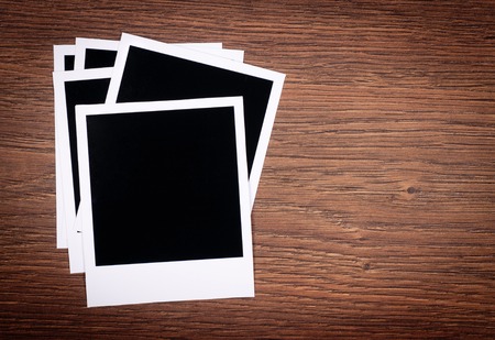 Designer concept - blank photo frames for your photos on wooden backgroundの写真素材