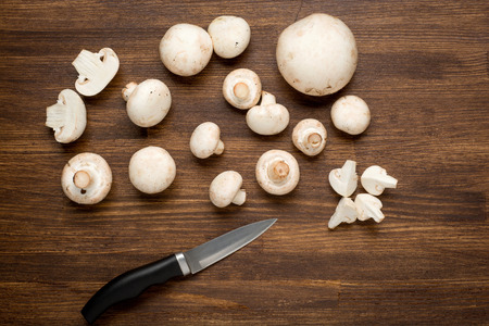 Fresh Mushroom on wooden background with knife .の写真素材